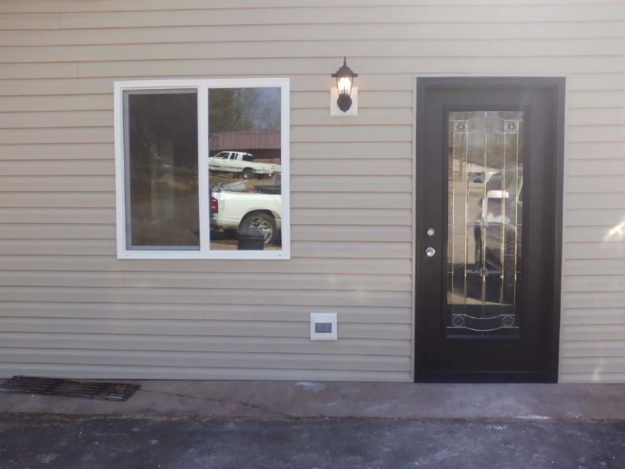 New siding, window and entry door on the side of an addition in Grandview
